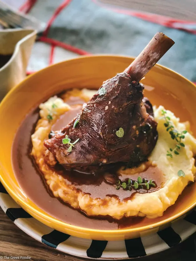 Braised Karoo lamb shank on mash in a yellow bowl