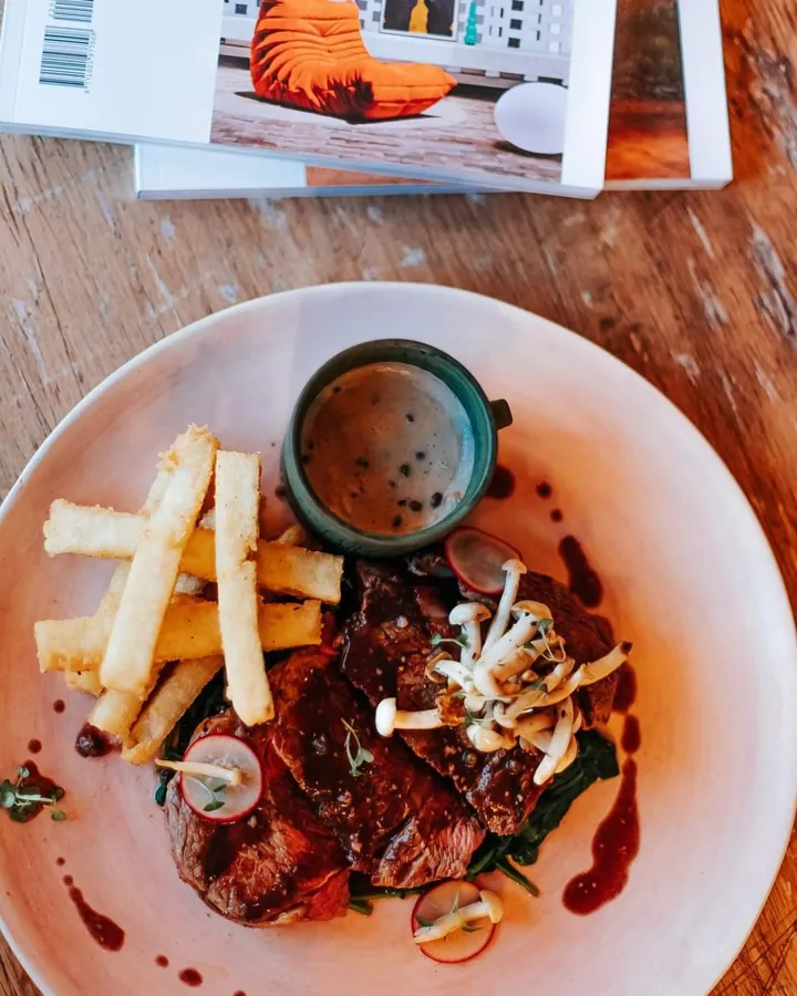 Sliced ribeye with pap chips and pepper sauce